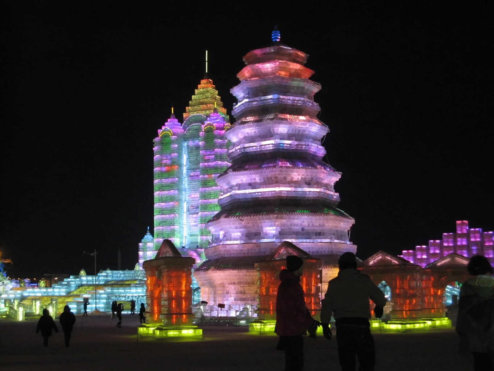 Illuminated ice pagodas at Harbin Ice and Snow World after dark