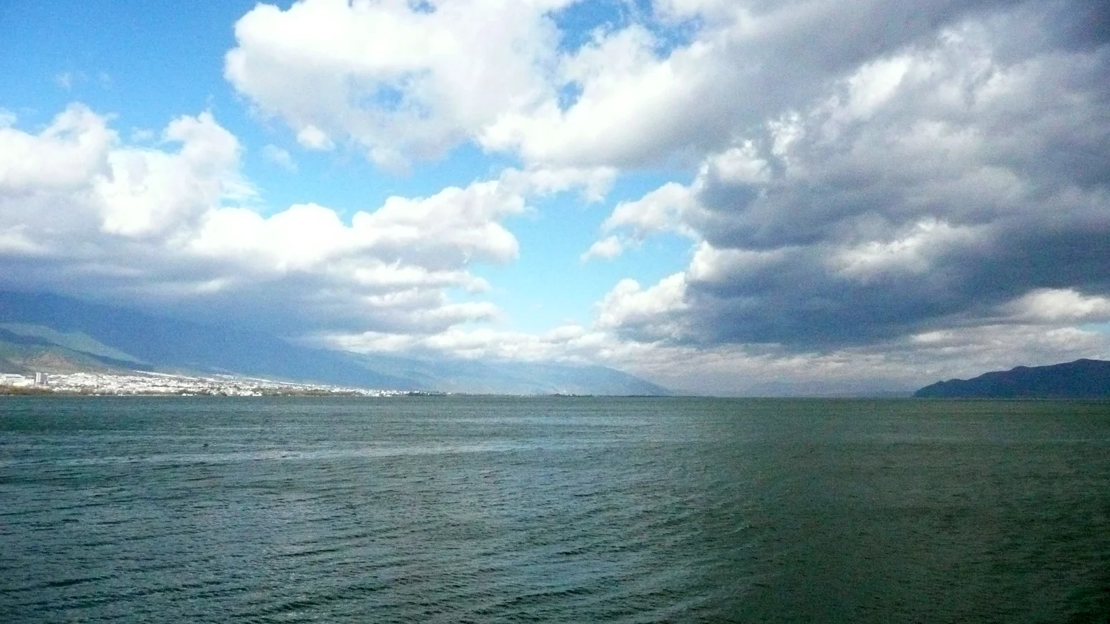 Erhai Lake beneath a wide cloudy sky near Dali