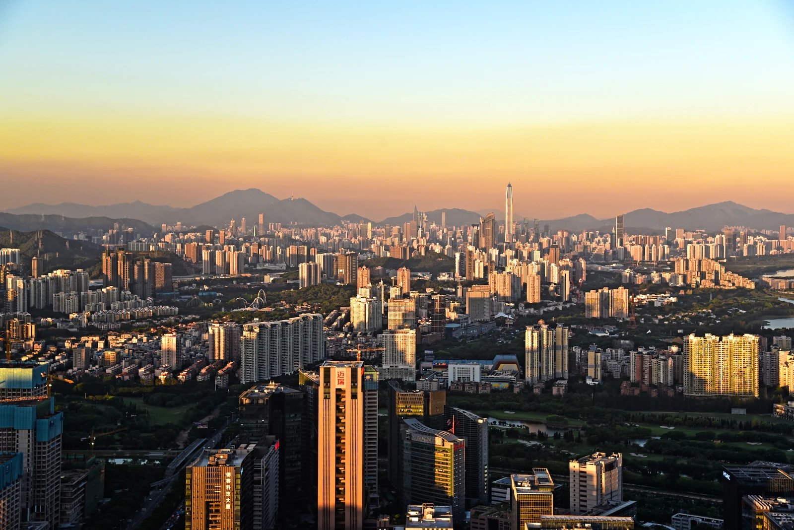 Warm sunset light over Shenzhen’s skyline and surrounding hills
