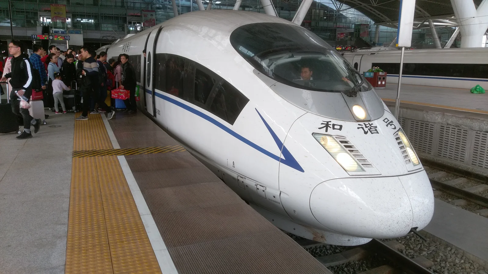 A white CRH high-speed train beside the passenger platform at Guangzhou South station
